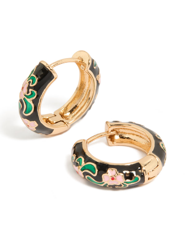 Featuring thick huggie earrings with floral pattern in enamel, statement style, gold and black with pink accents front view