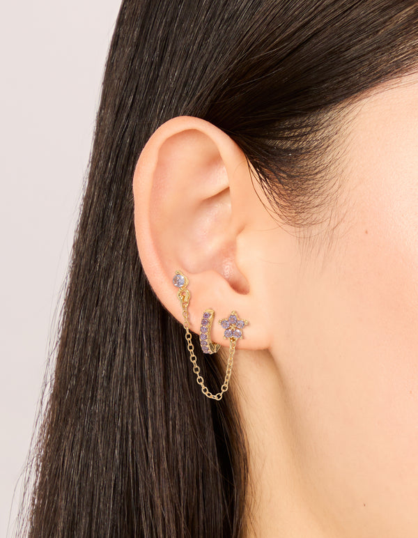 Featuring dainty cubic zirconia chain flower and huggie earrings pack with crystal in gold and stud closure on ear view