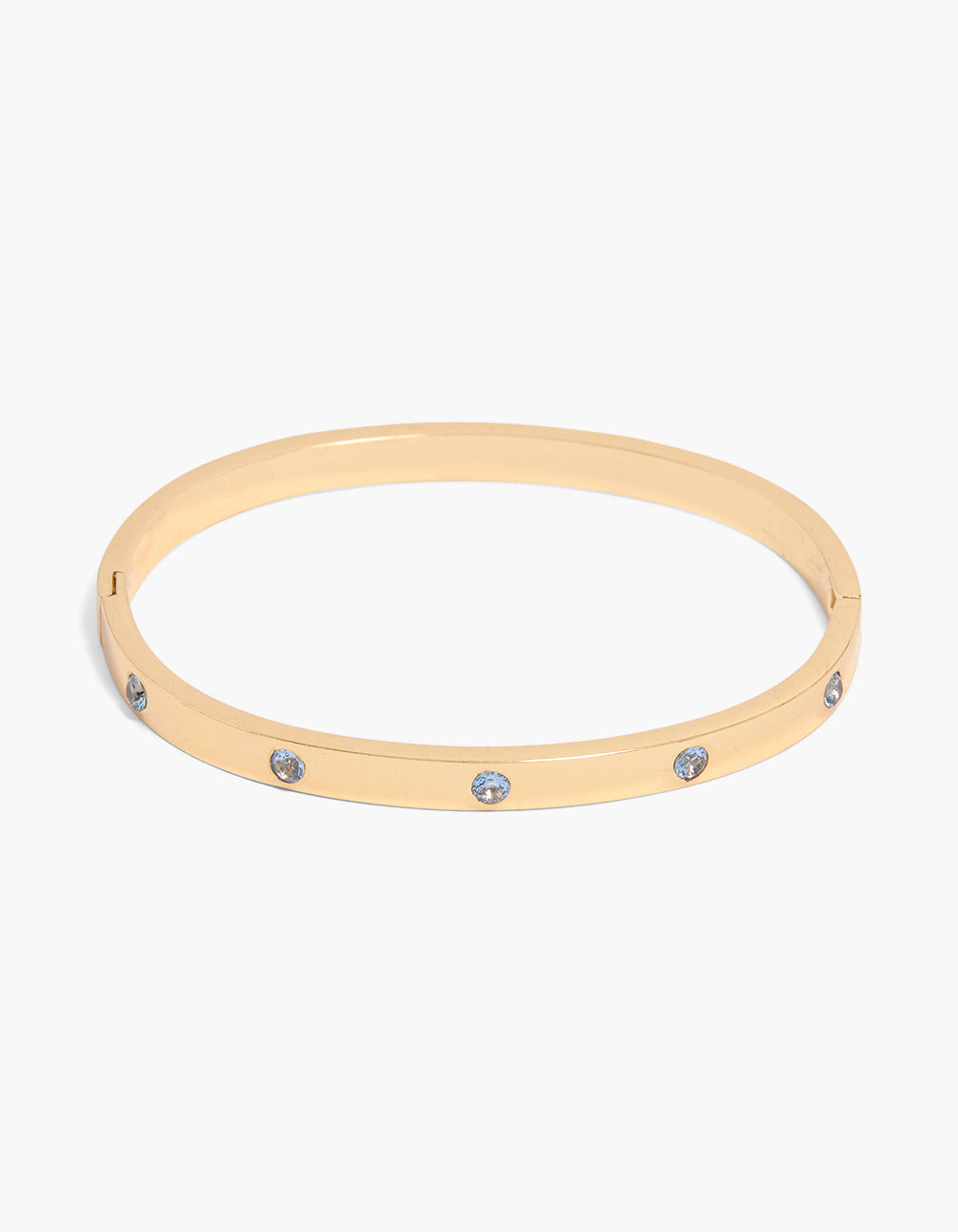Showcasing a waterproof gold plated stainless steel diamantes hinged bangle with light blue accents front view