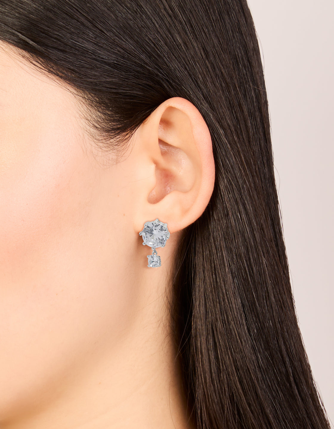 Elegant silver cubic zirconia double circle drop earrings with clear accents on ear view