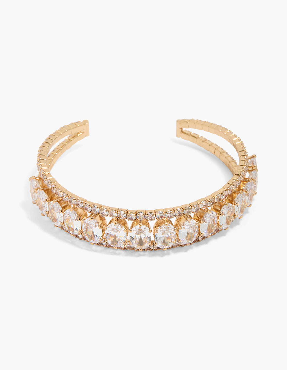 Showcasing a gold statement wrist cuff with oval cubic zirconia stones front view