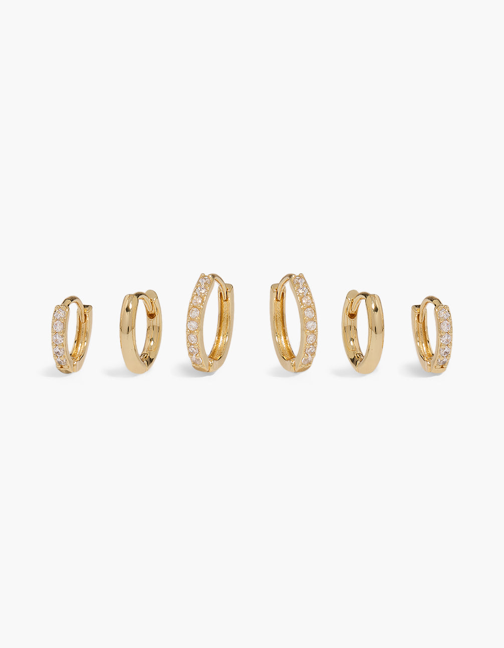 Showcasing gold plated cubic zirconia and plain huggie earrings in a 3-pack with crystal front view