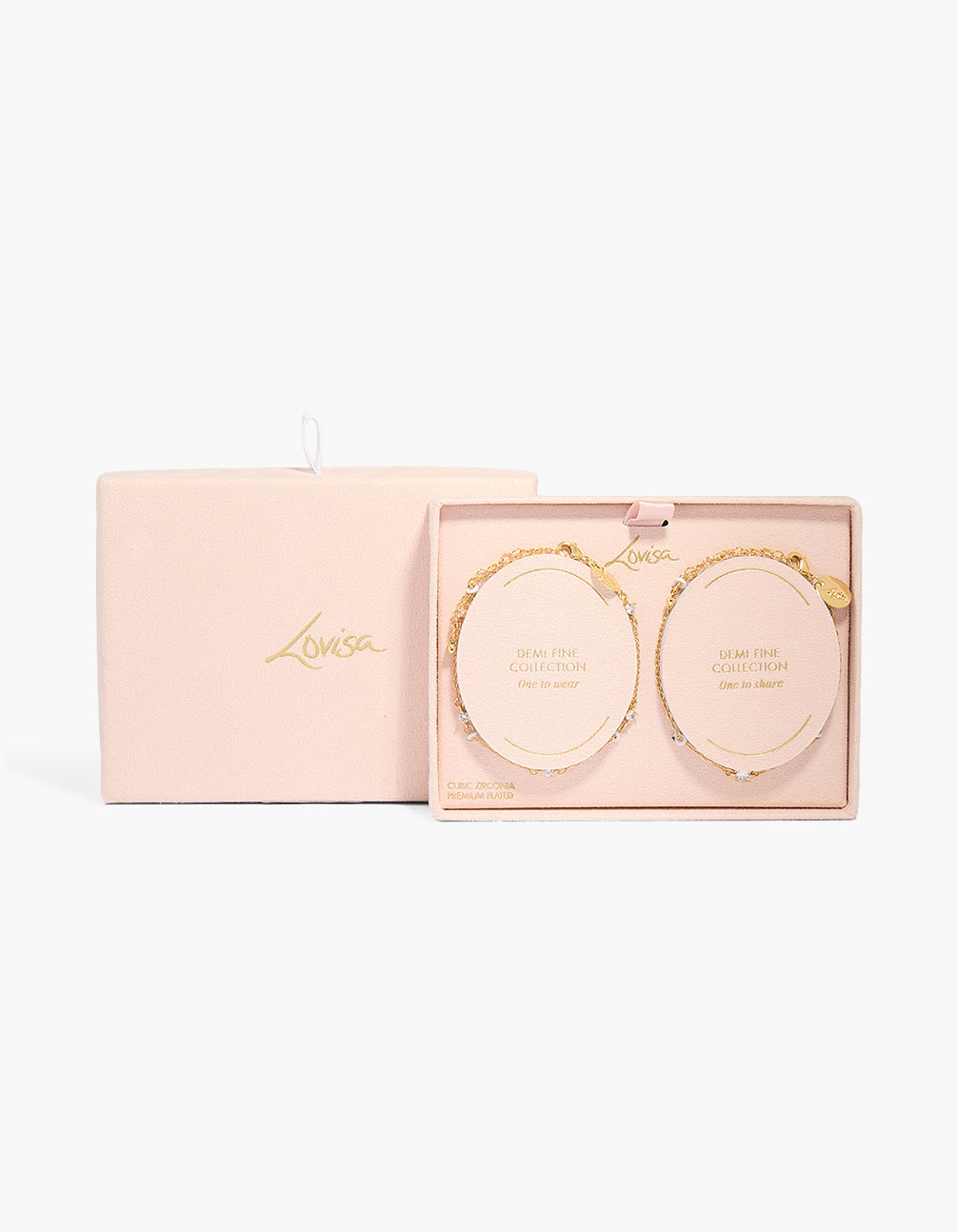 Showcasing crystal cubic zirconia chain bracelet in a 2-pack set crafted from gold plated material shown in a packaging close up view