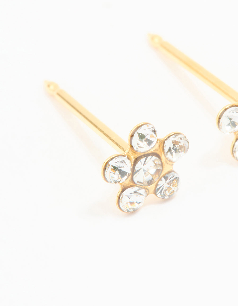 Showcasing 24K gold plated surgical stainless steel cubic zirconia daisy piercing stud with floral pattern and dainty details in clear close up view