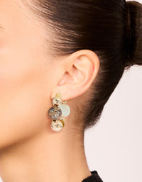 Showcasing chunky beaded ball hoop earrings in gold with neutral tones on ear view - link has visual effect only