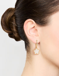 Showcasing gold plated flower drop diamante hoop earrings in white on ear view - link has visual effect only