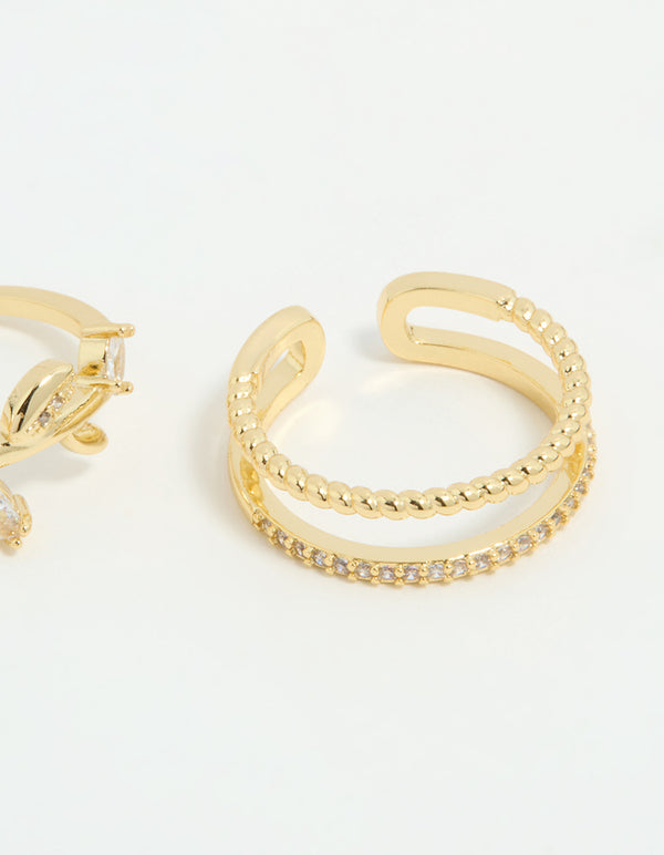 Featuring gold plated cubic zirconia leafy station rings in a 3-pack side detail view