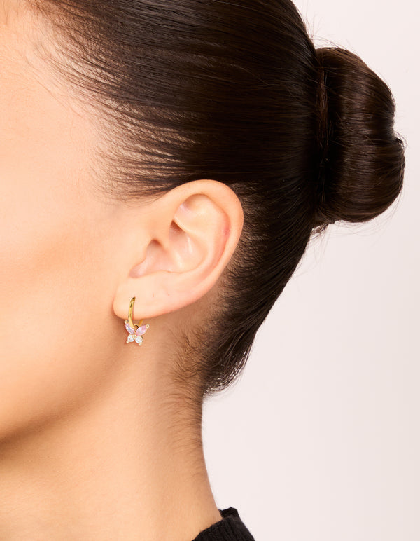 Stylish gold plated surgical steel butterfly sleeper earrings with pink cubic zirconia on ear view