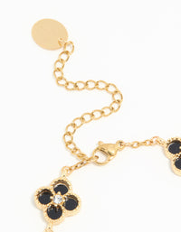 Highlighting the waterproof charm floral bracelet with gold plated stainless steel and diamante black inlay flowers closure detail view - link has visual effect only