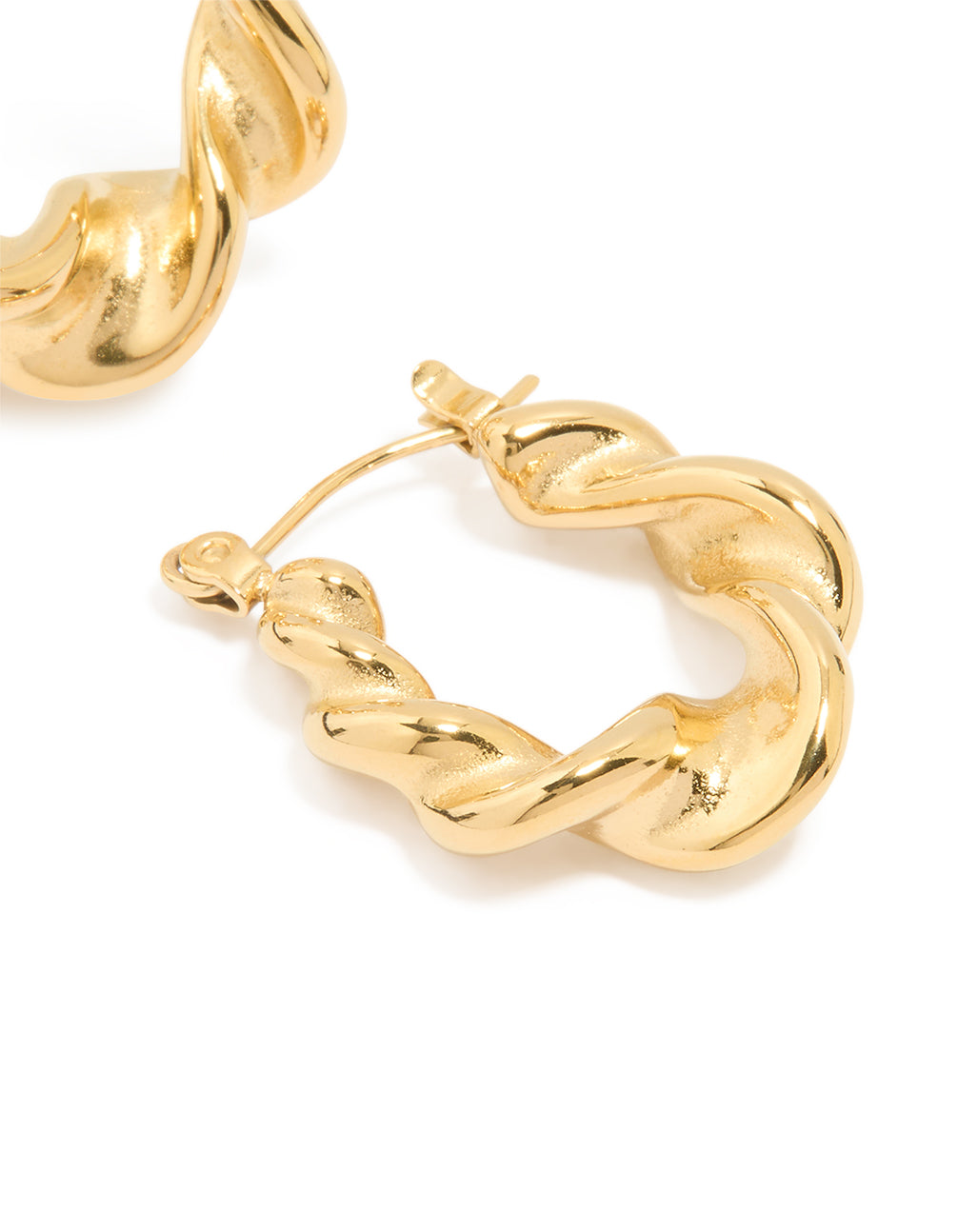 Highlighting large twisted statement hoop earrings made from waterproof gold plated stainless steel with smooth finish post detail view