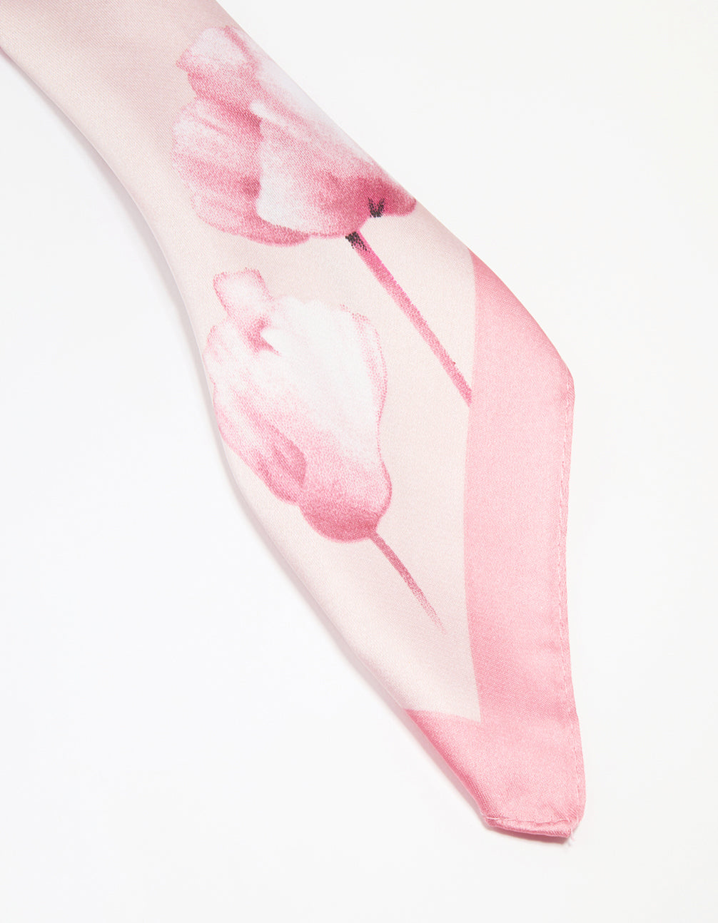 Crafted fabric scarf in light pink with flower border displaying white floral pattern detail view