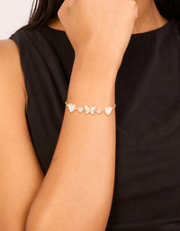 Showcasing a gold plated cubic zirconia butterfly and heart toggle bracelet on wrist view - link has visual effect only