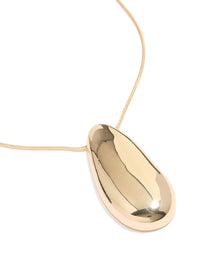 Showcasing a gold chain oval pendant necklace with polished finish close up view - link has visual effect only
