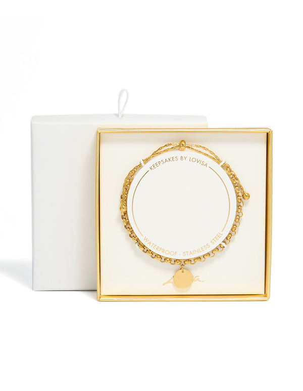 Highlighting a disc toggle chain bracelet in waterproof gold plated stainless steel close up view