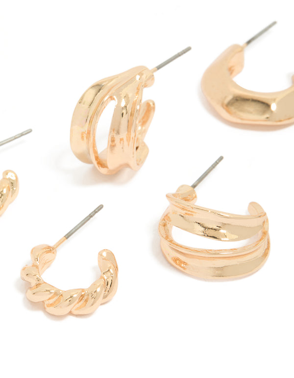 Featuring dainty chunky earrings with textured huggie closure in gold, 3 pack close up view