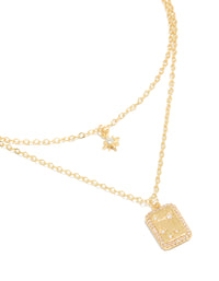Showcasing a gold plated cubic zirconia celestial and rectangle cluster layered necklace close up view - link has visual effect only