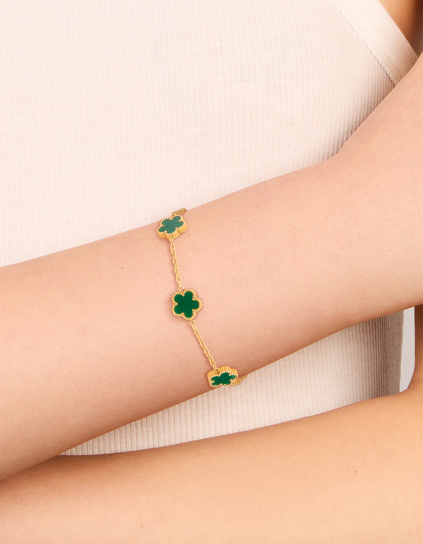 Featuring waterproof gold plated stainless steel dark green petal flower charm bracelet on wrist view