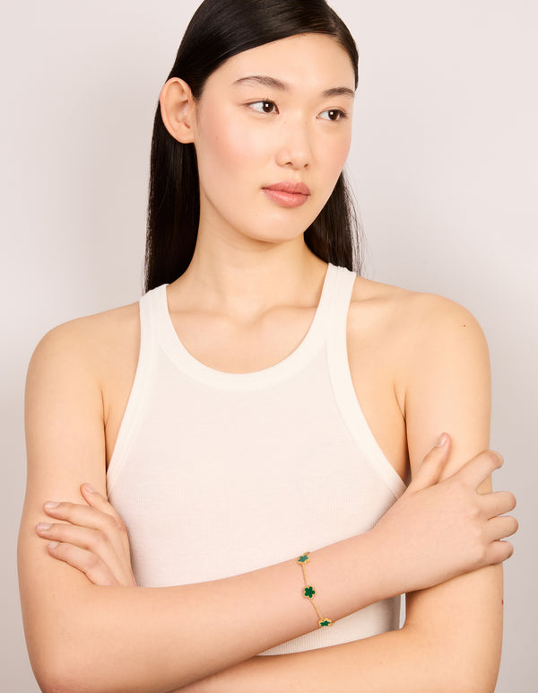 Showcasing waterproof gold plated stainless steel dark green petal flower charm bracelet on model view