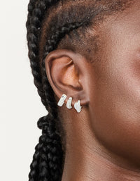 Featuring waterproof stainless steel chunky huggie earrings in silver finish, available as a pack of 3 on ear view - link has visual effect only