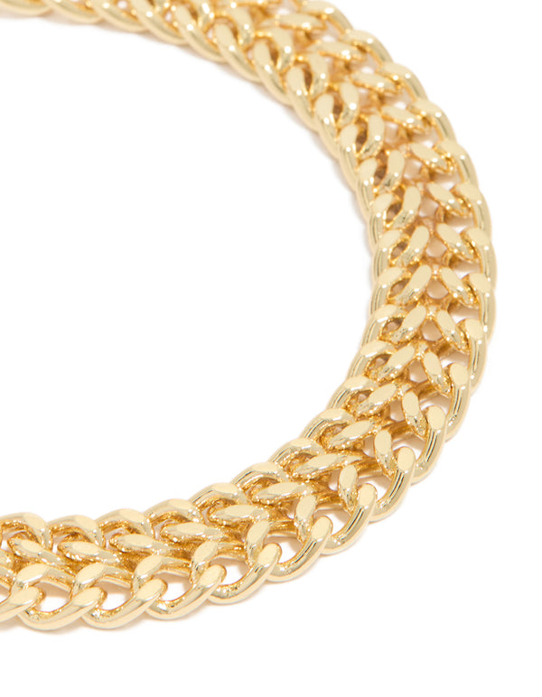 Highlighting the double flat curb chain bracelet with gold plated finish and textured link detail close up view