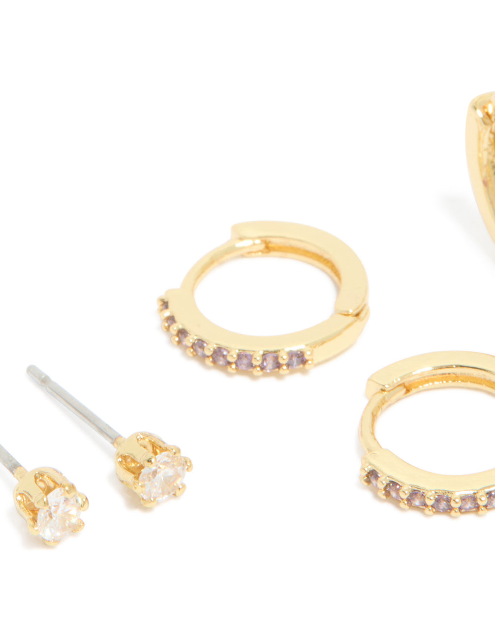 Beautifully crafted gold plated brass amethyst cubic zirconia February birthstone earrings in a 4-pack with ball stud, hoop, and huggie closures featuring crystal accents close up view