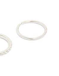 Showcasing surgical steel cubic zirconia hinged and plain nose rings in a 2-pack with diamond accents and silver finish close up view - link has visual effect only