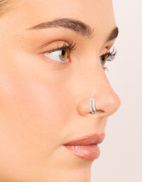 Showcasing surgical steel cubic zirconia hinged and simple nose rings in a 2-pack with diamond accents and statement style nose view - link has visual effect only