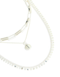 Showcasing a disc chain layered necklace crafted from silver plated material in statement style front view - link has visual effect only