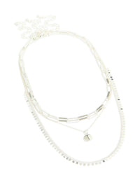 Featuring a disc chain layered necklace in silver plated material with statement style close up view - link has visual effect only