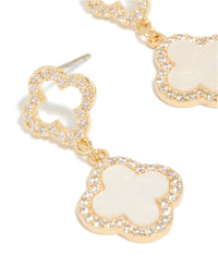 Detailed view of gold plated floral earrings with cubic zirconia and pink inlay close up view - link has visual effect only