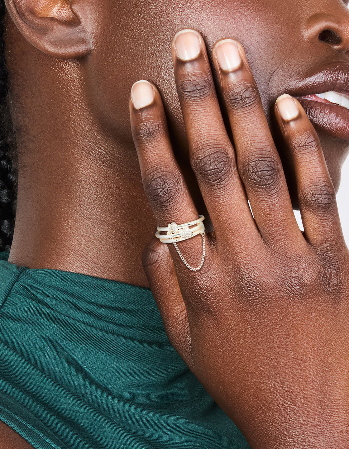 Showcasing a silver plated cubic zirconia loop linked stacking ring set featuring crystal on finger view