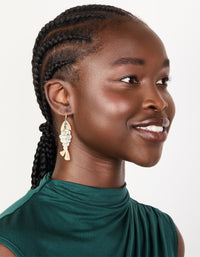 Designed with gold these evil eye fish drop earrings featuring animal and ocean inspired charm in statement style on model view - link has visual effect only