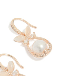 Highlighting the intricate floral butterfly design with dainty white pearl and cubic zirconia stones in rose gold plated metal post detail view - link has visual effect only