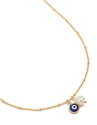 Showcasing a gold plated brass necklace featuring evil eye charm with pearl pendant close up view - link has visual effect only