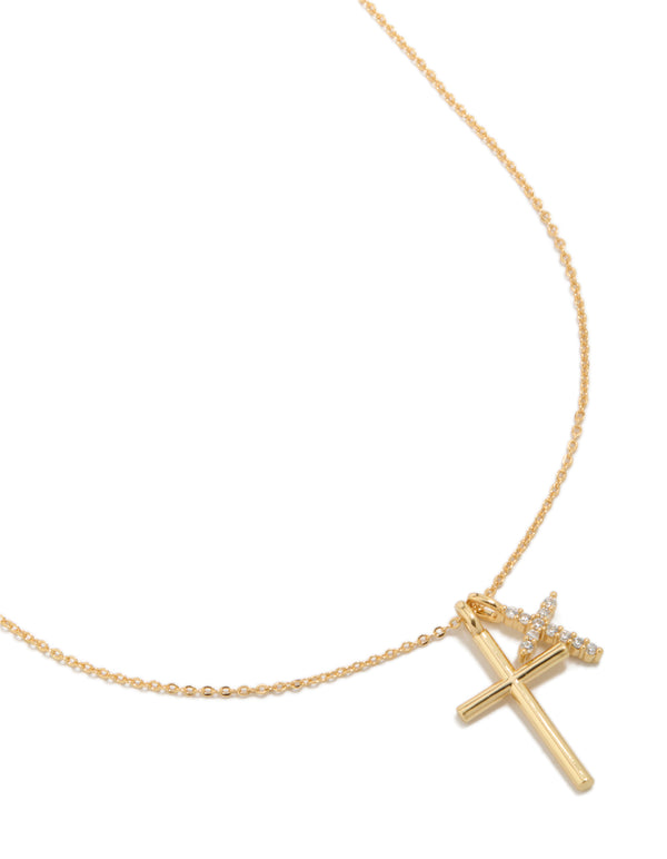 Showcasing a gold plated brass double cubic zirconia cross necklace with charm featuring statement styling close up view