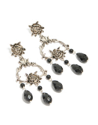 Showcasing drop earrings featuring floral design with beaded accents, charm elements in silver and black statement style front view - link has visual effect only