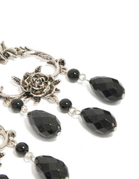 Crafted from silver with floral, beaded and charm in black, these drop earrings highlight statement style on ear view - link has visual effect only