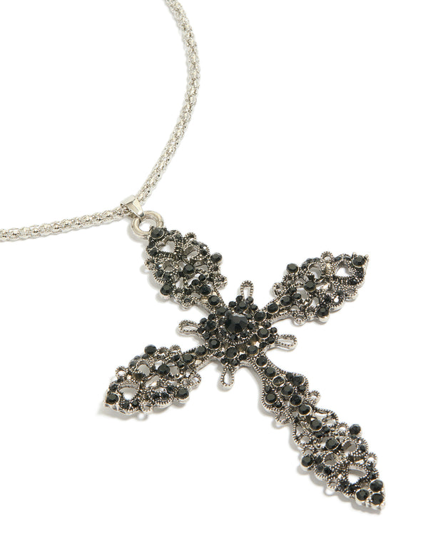 Showcasing a silver necklace with black diamante cross pendant close up view