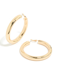 Showcasing gold large thick hoop earrings with statement style in a front view - link has visual effect only