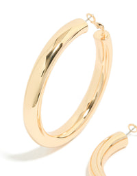 Featuring gold large thick hoop earrings with statement style in a close up view - link has visual effect only
