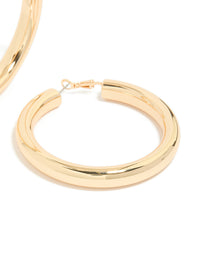 Crafted from gold, these large thick hoop earrings feature statement style in a post detail view - link has visual effect only