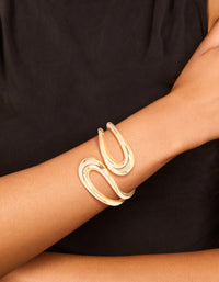 Showcasing a gold wrapped loop hinged bangle in a stunning on wrist view - link has visual effect only