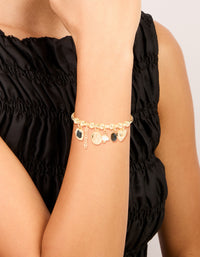 Showcasing a gold heart and black stone charm bracelet with balls, coin and pearl accents on wrist view - link has visual effect only