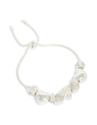 Elegant silver diamante heart charm toggle bracelet featuring balls front view - link has visual effect only