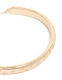 Elegant gold celestial diamante toggle bangle in close up view - link has visual effect only