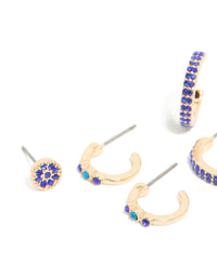 Featuring gold diamante evil eye and cross earrings in a 5-pack, hoop and stud closures in blue and aqua tones close up view - link has visual effect only