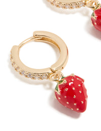 Crafted from gold cubic zirconia, these strawberry huggie earrings feature fruit accents in red, green, and white close up view - link has visual effect only