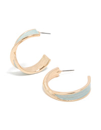 Showcasing twisted hoop earrings in gold featuring light blue enamel with marble pattern and statement styling front view - link has visual effect only