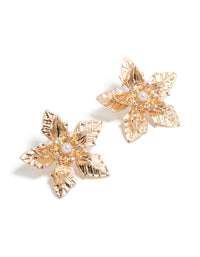 Dainty gold textured flower stud earrings featuring floral with pearl accents front view - link has visual effect only