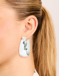 Showcasing silver plated smooth thick hoop earrings with closure on ear view - link has visual effect only